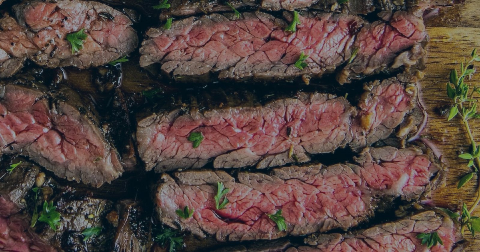 Sliced grilled steak with fresh herbs