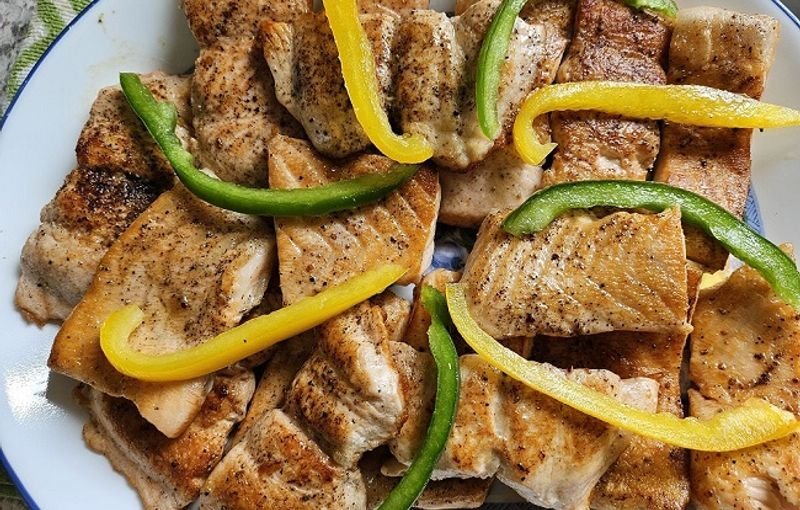 Grilled fish with green and yellow peppers